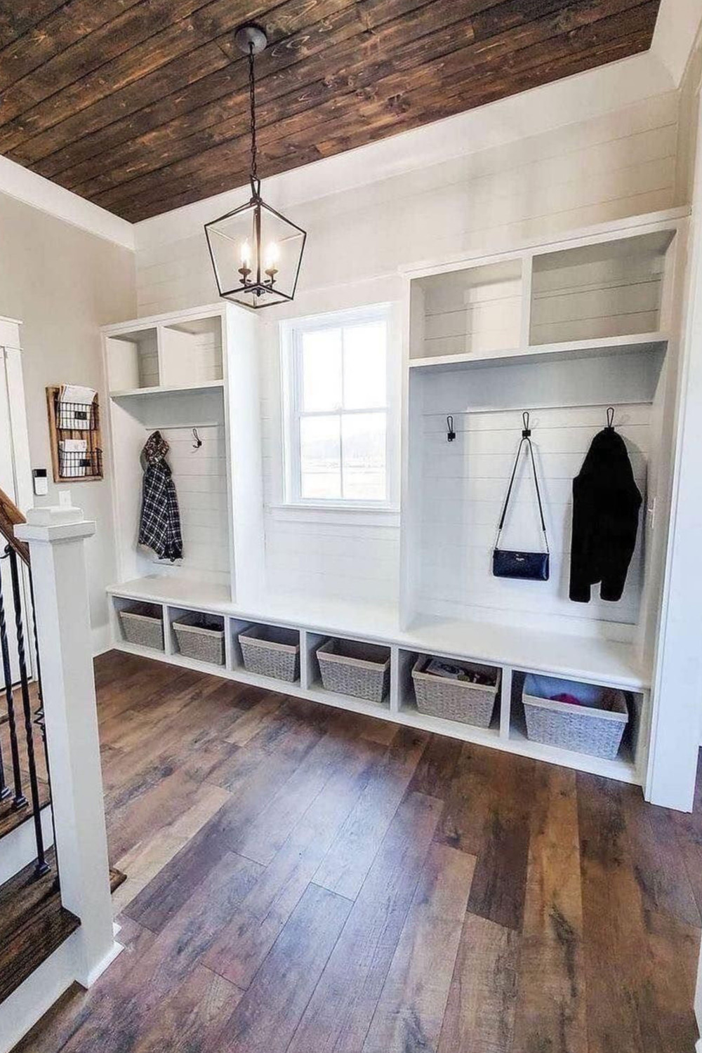 Full wall mud room with window cubbies baskets hooks shelves stairway entryway drop zone