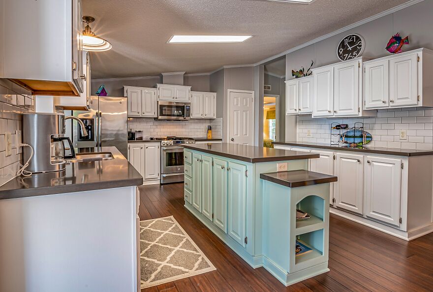 Turquoise kitchen island cabinet paired with modern white kitchen cabinets in a stylish and contemporary kitchen design.