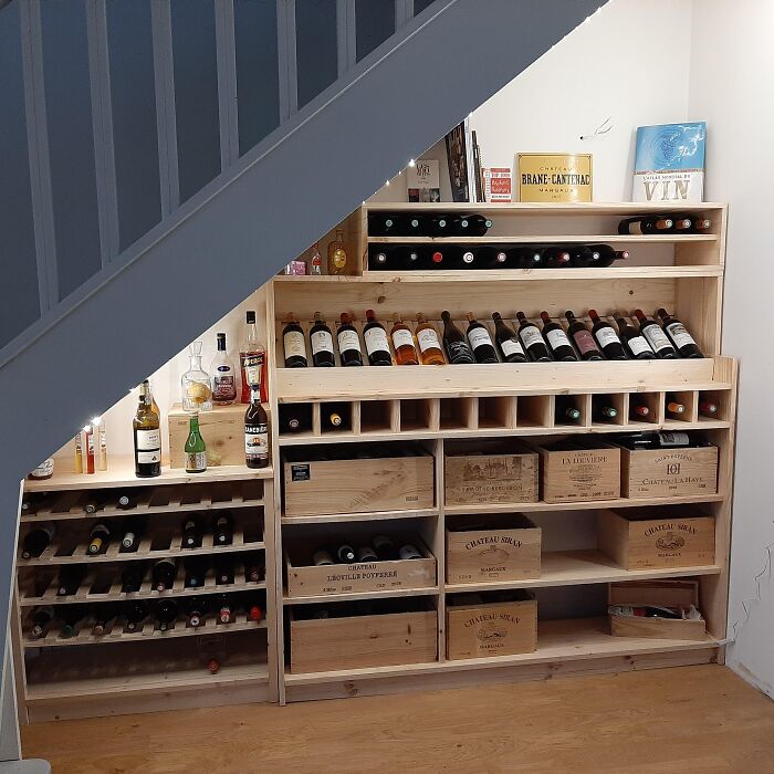 Dining room wine rack storage with bottles and wooden crates, creating inspiring ideas to beautify family gatherings and