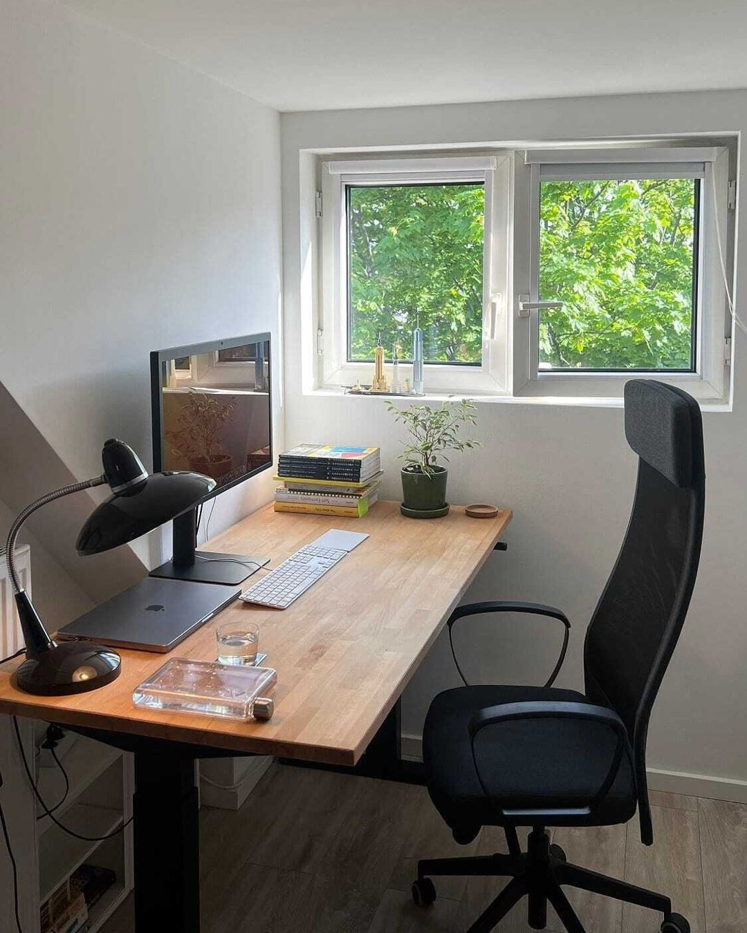 7. Bright Window Workspace with Natural Wood Desk - small room office ideas
