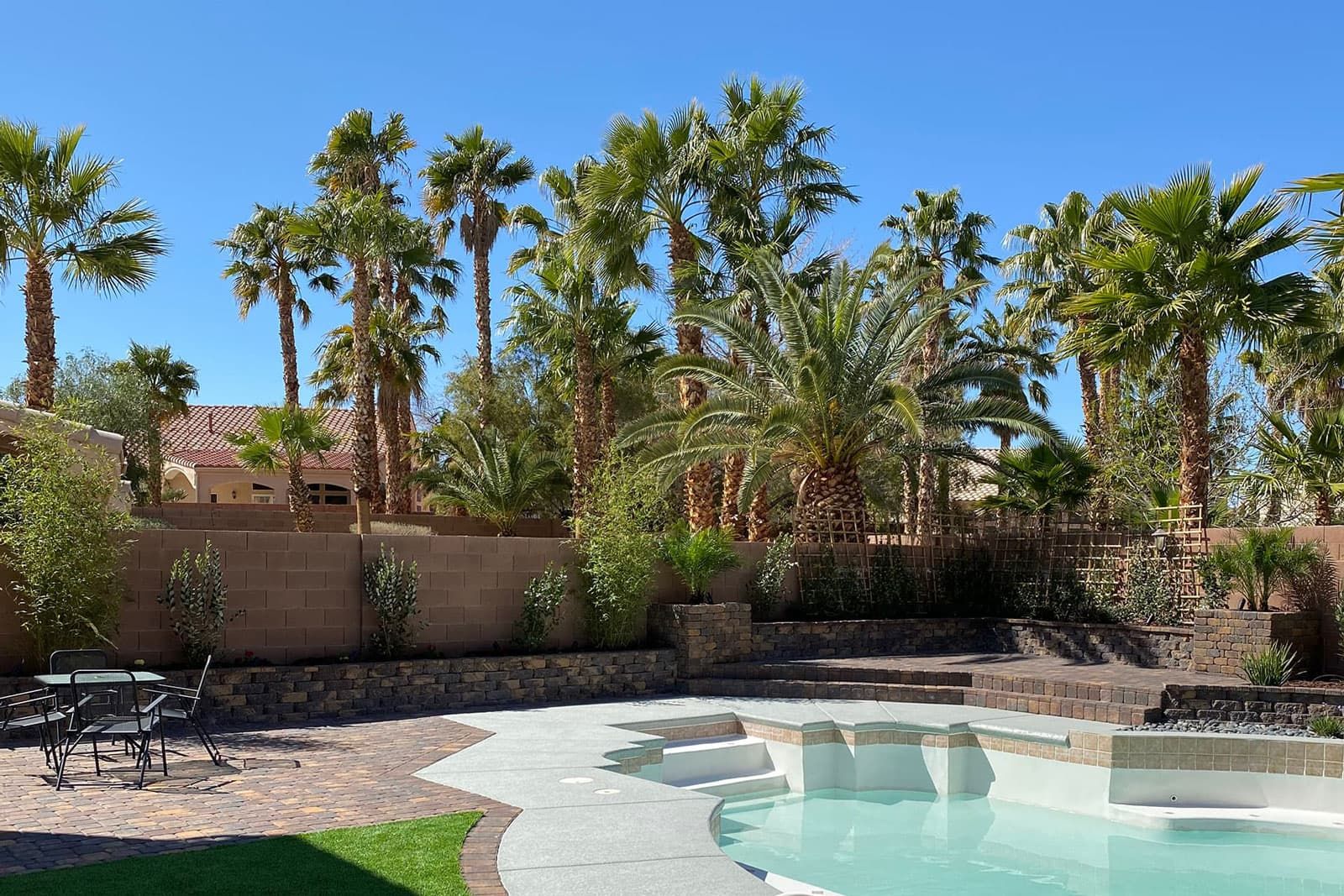 A Las Vegas Home With Professional Landscaping, Including Tree Service, Artificial Turf And Outdoor Lighting.