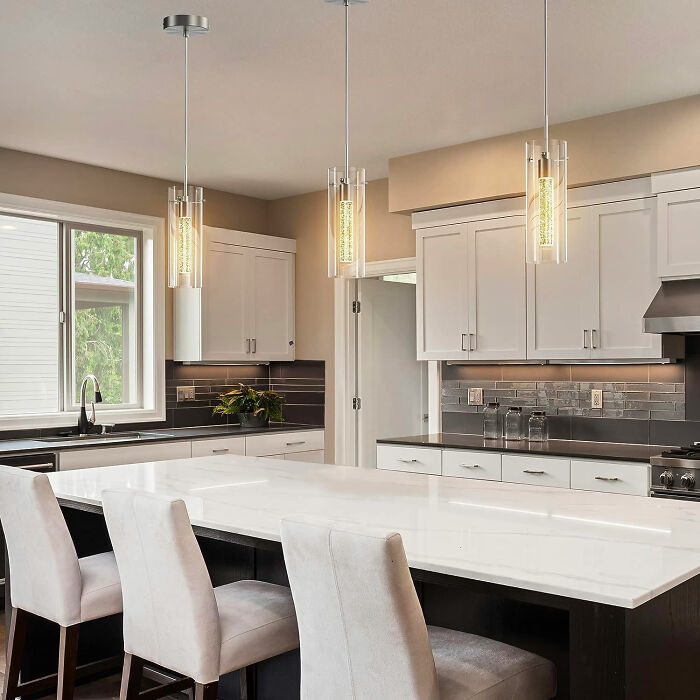 White dining room with modern white chairs and pendant lights, showcasing inspiring dining room ideas for family gatheri