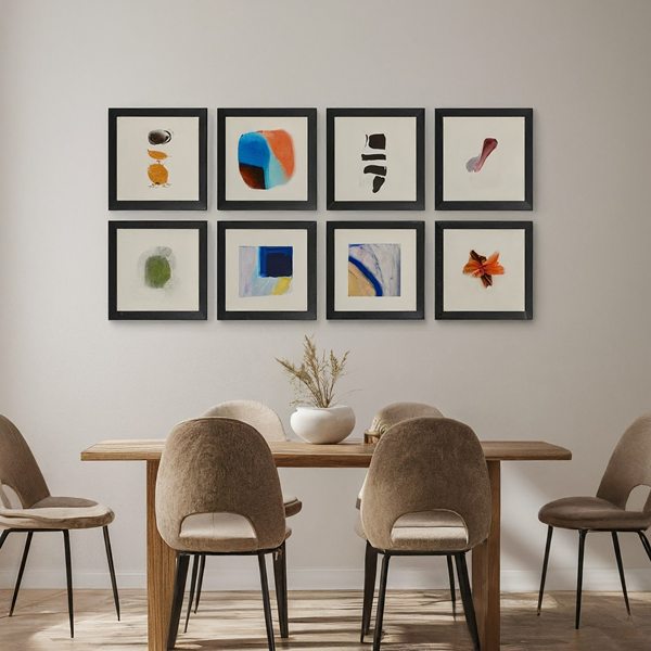 a grid style gallery wall in a modern dinign room frames are arrangined in a perfect row and column