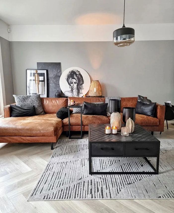 Modern living room with brown accent details, black cushions, contemporary art, and stylish home decor ideas for a cozy