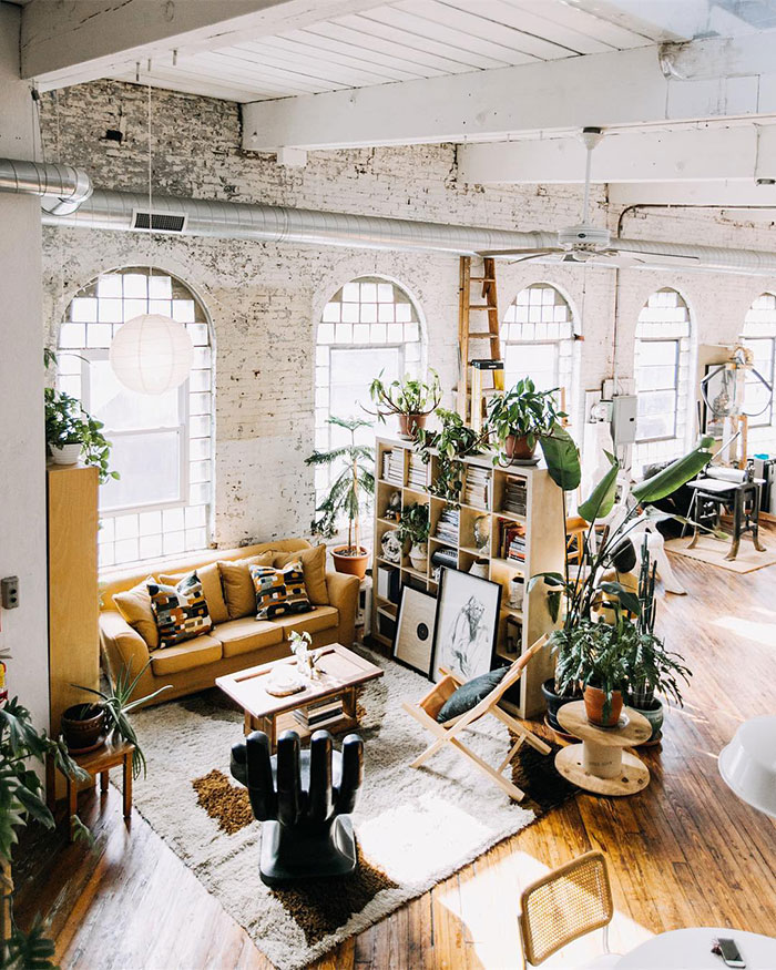 Spacious industrial living room with abundant plants, natural light, and stylish home decor ideas featuring designer ins