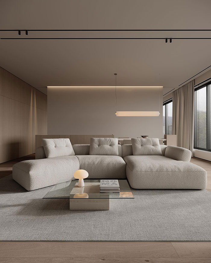 Spacious minimalistic living room with modern beige sofa and glass coffee table showcasing home decor ideas and designer
