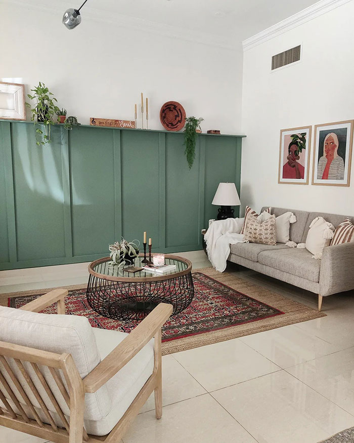 Scandinavian style living room with green accent wall, cozy seating, patterned rug, and curated home decor ideas for mod