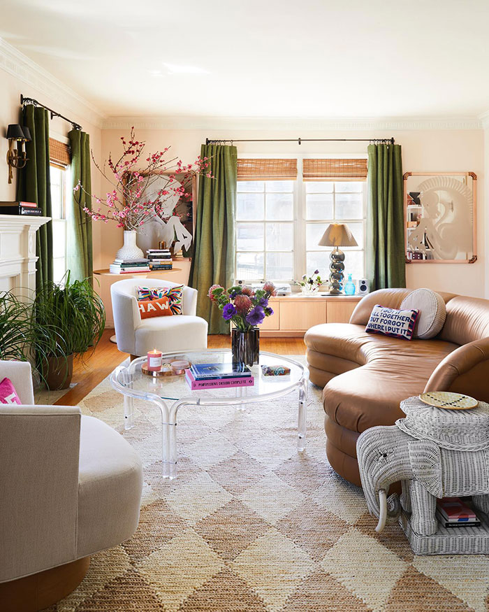 Electric and vibrant colorful living room with eclectic furniture, green curtains, and designer-inspired home decor idea