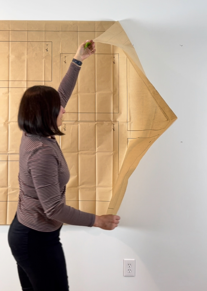 Stefana Silber puling gallery template off the wall after nails are hammered into the wall