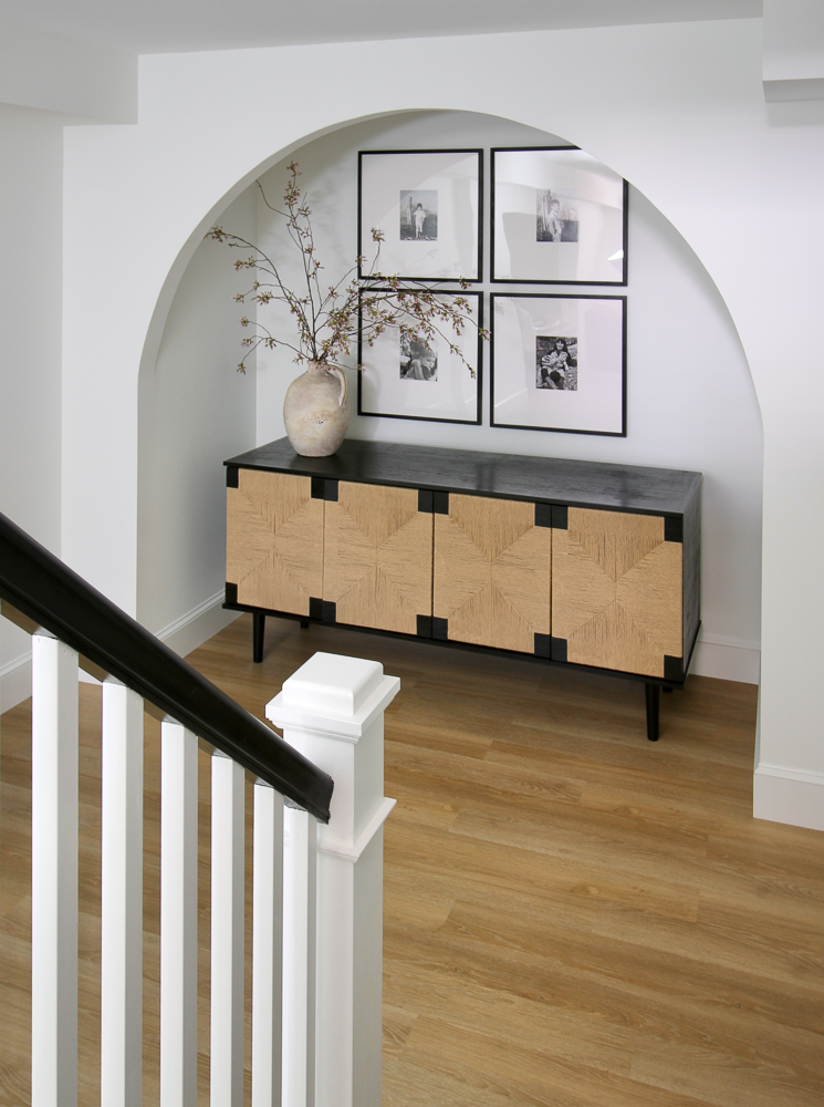 Woven cabinet and large framed photos